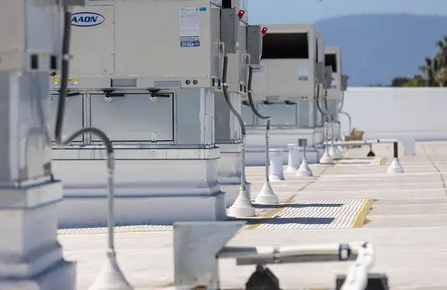 Row of rooftop HVAC units installed on a Bay Area commercial building